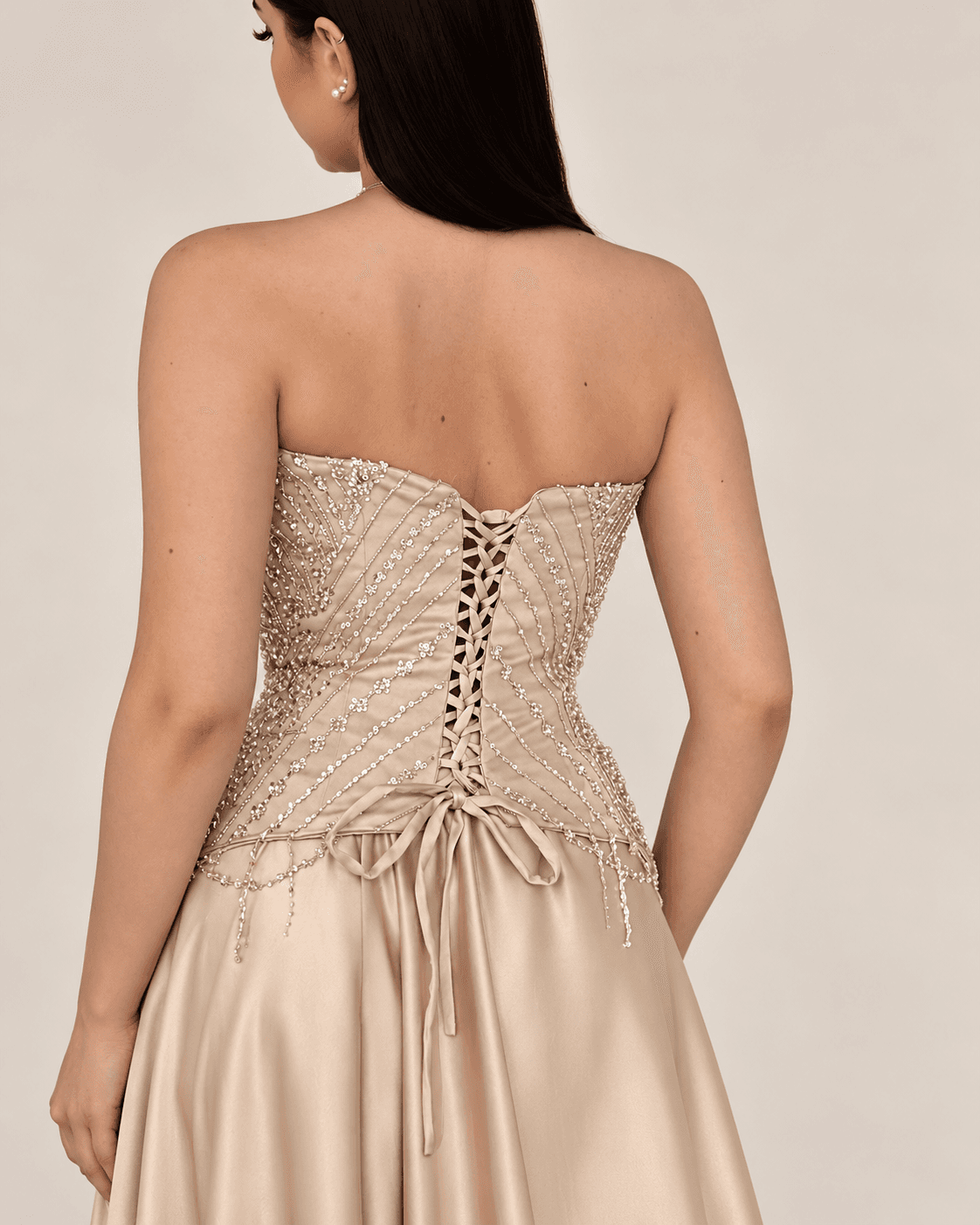 Champagne bead gown — seated side view